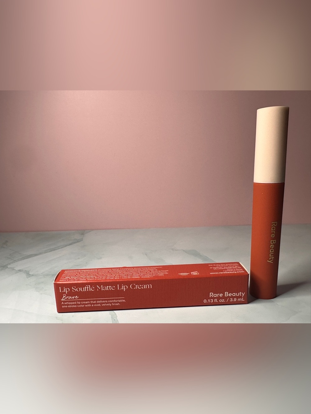Rare Beauty Soufflé Matte Lip Cream in Coral-Red Packaging